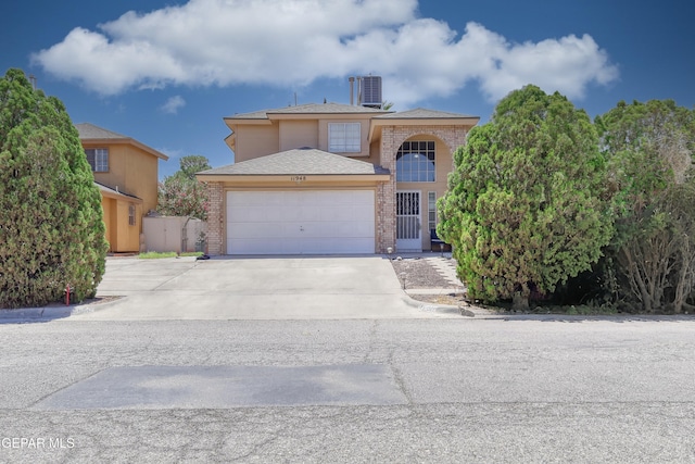 11948 Mcauliffe Dr, El Paso, TX 79936 - traditional-style house with brick siding, a garage, concrete driveway, and cooling unit