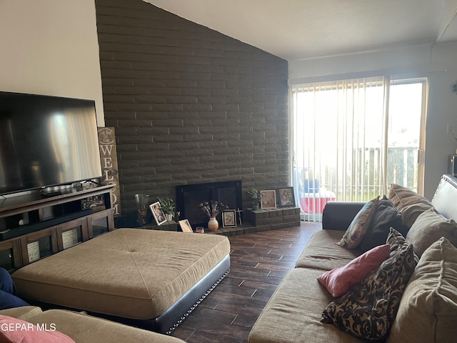 bedroom featuring a large fireplace and lofted ceiling