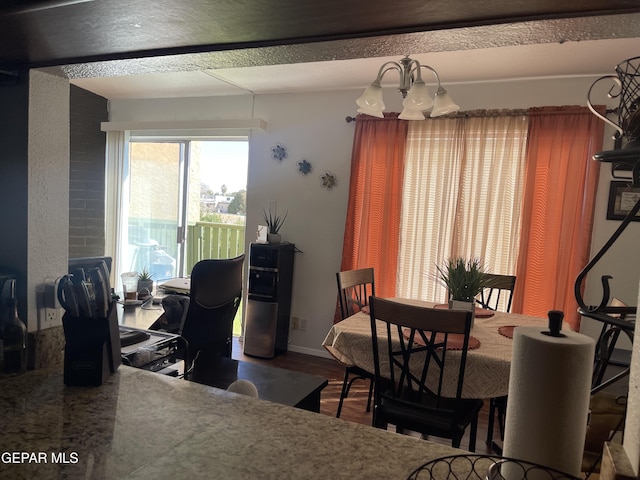 dining space with hardwood / wood-style flooring and a chandelier