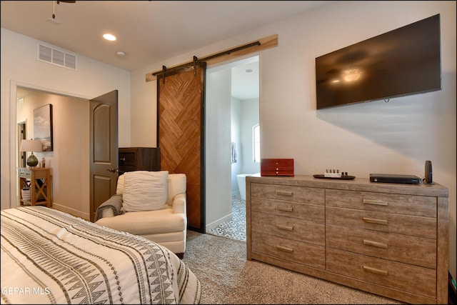 carpeted bedroom with a barn door