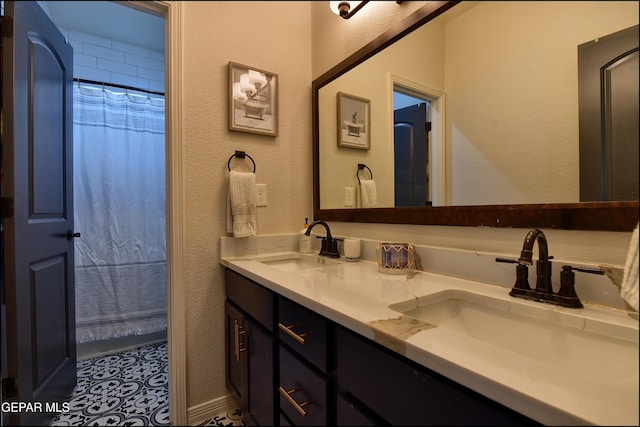 bathroom with tile patterned flooring and vanity