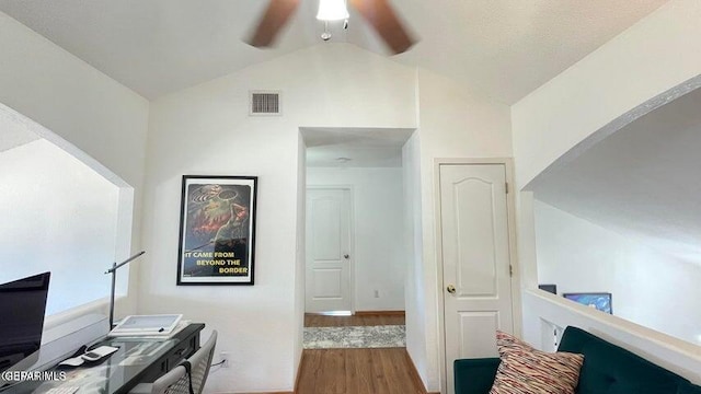 home office featuring hardwood / wood-style flooring and lofted ceiling