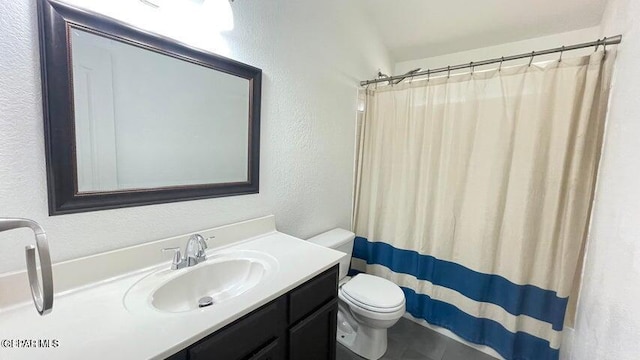 bathroom with vanity, toilet, and walk in shower