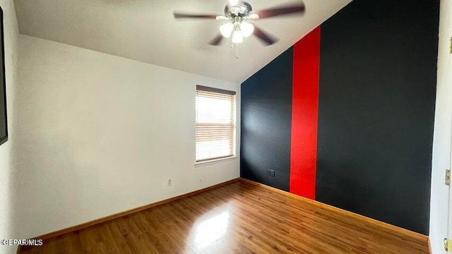 spare room featuring ceiling fan, wood-type flooring, and lofted ceiling