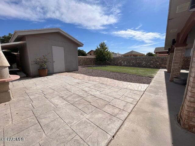 view of patio / terrace featuring a storage unit