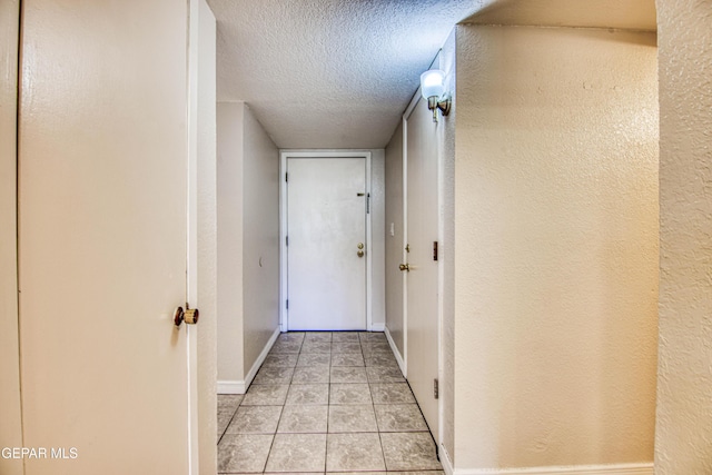 hall with a textured ceiling