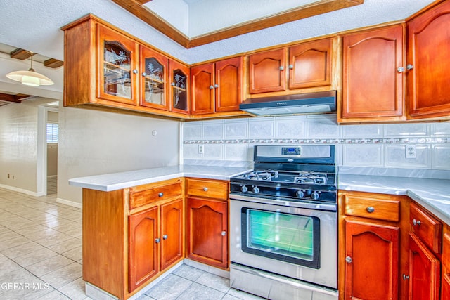 kitchen with gas stove, backsplash, light tile patterned flooring, and a textured ceiling