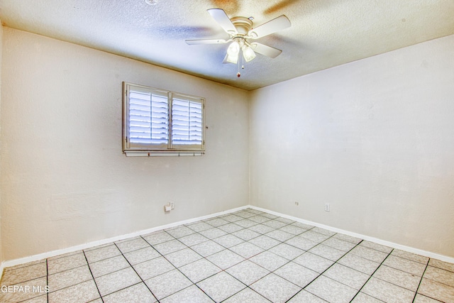 empty room featuring ceiling fan and a textured ceiling