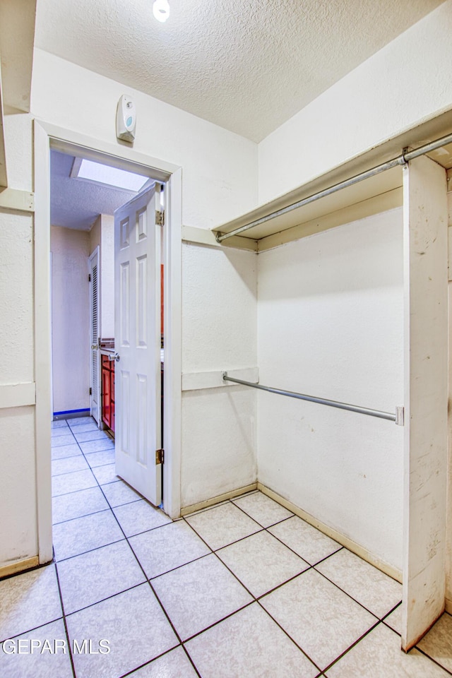 walk in closet featuring tile patterned flooring