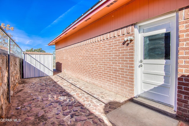 view of exterior entry featuring a patio area