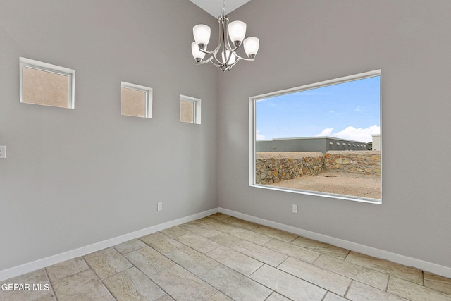 unfurnished dining area featuring vaulted ceiling and an inviting chandelier