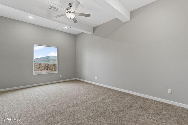 spare room with ceiling fan, carpet floors, and beamed ceiling