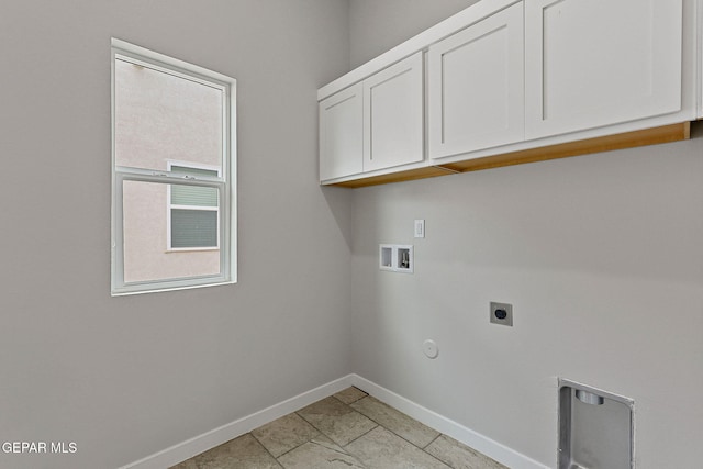 washroom featuring gas dryer hookup, washer hookup, electric dryer hookup, and cabinets