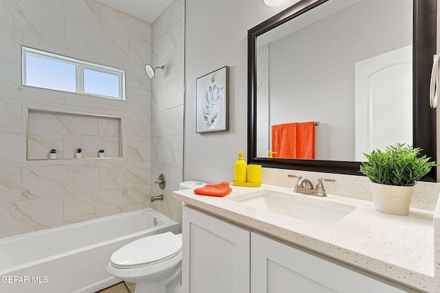 full bathroom featuring toilet, vanity, and tiled shower / bath