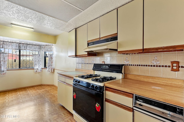 kitchen featuring white range with gas cooktop, dishwashing machine, and light parquet floors