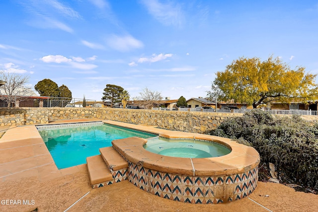 view of pool with an in ground hot tub