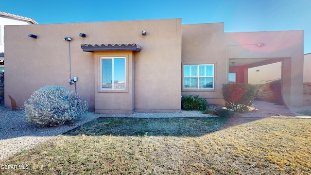 rear view of property featuring a yard