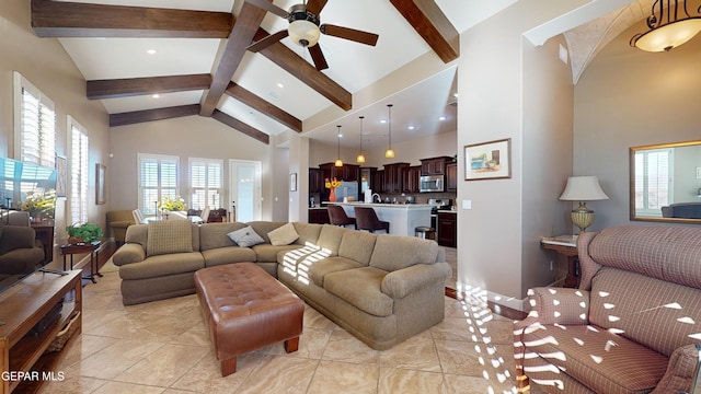 living room featuring beam ceiling, ceiling fan, and high vaulted ceiling