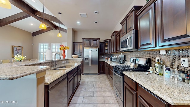 kitchen featuring a large island with sink, hanging light fixtures, vaulted ceiling with beams, appliances with stainless steel finishes, and tasteful backsplash