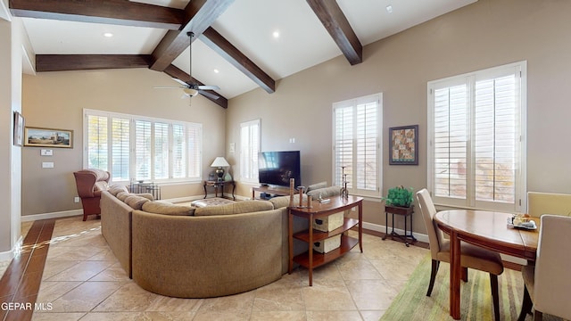 tiled living room with vaulted ceiling with beams and ceiling fan