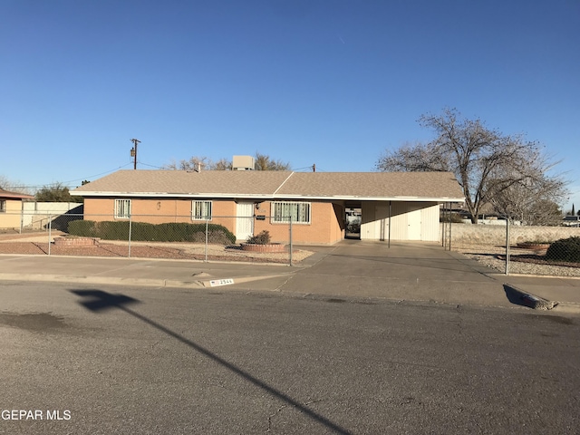 ranch-style house featuring a carport