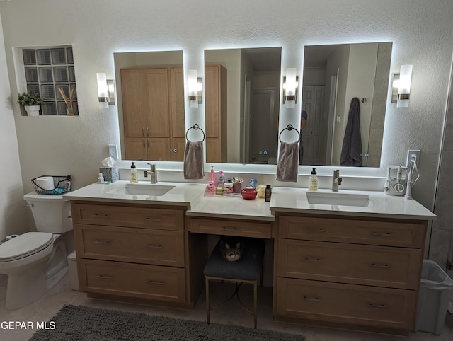 bathroom with tile patterned floors, vanity, and toilet