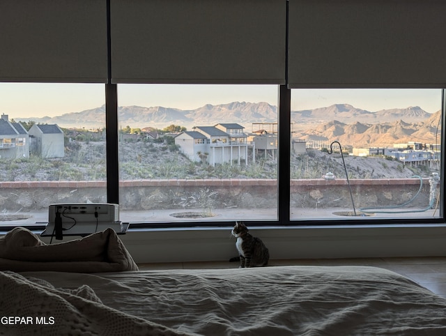 bedroom with a mountain view and wood-type flooring