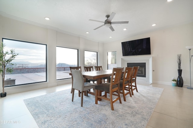 dining space featuring ceiling fan, light tile patterned floors, and ornamental molding