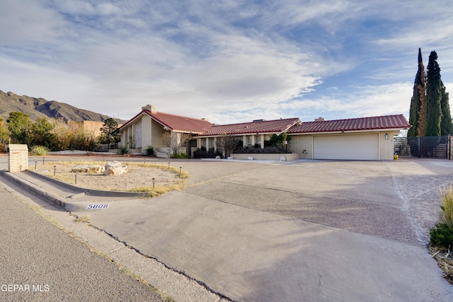 single story home with a mountain view and a garage