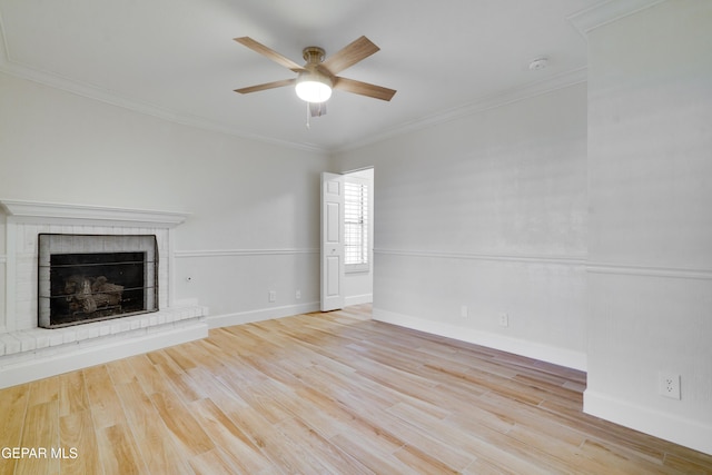 unfurnished living room with light hardwood / wood-style flooring, a brick fireplace, ceiling fan, and ornamental molding