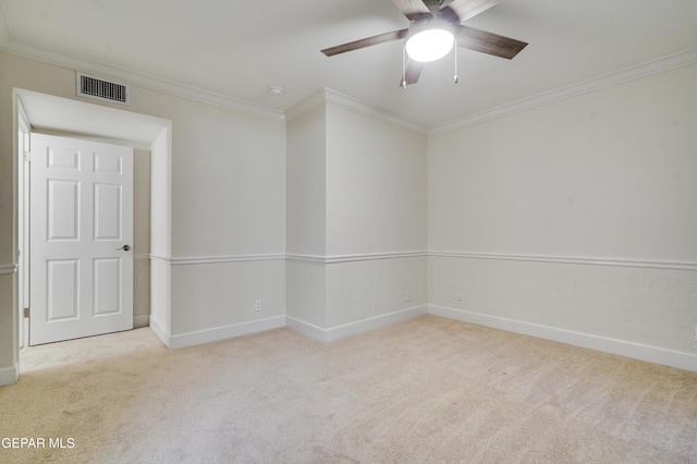 carpeted empty room featuring ceiling fan and ornamental molding