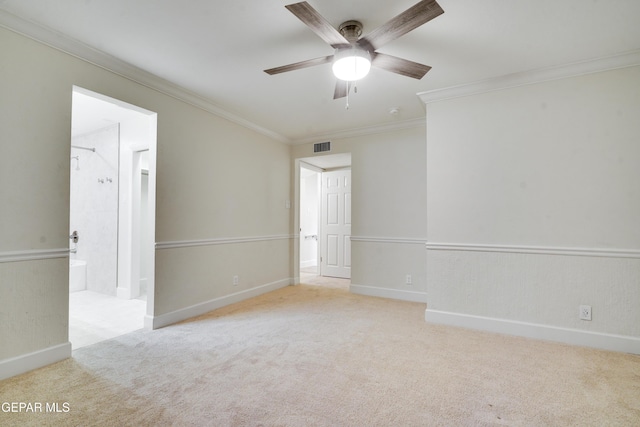 carpeted empty room with ceiling fan and crown molding