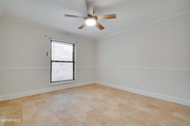 tiled empty room with ceiling fan and ornamental molding