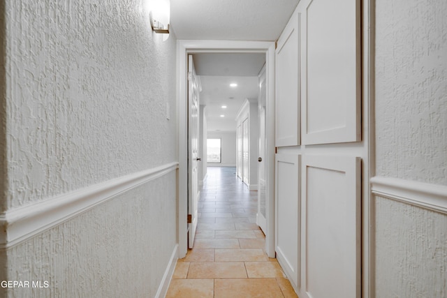 hall featuring light tile patterned floors