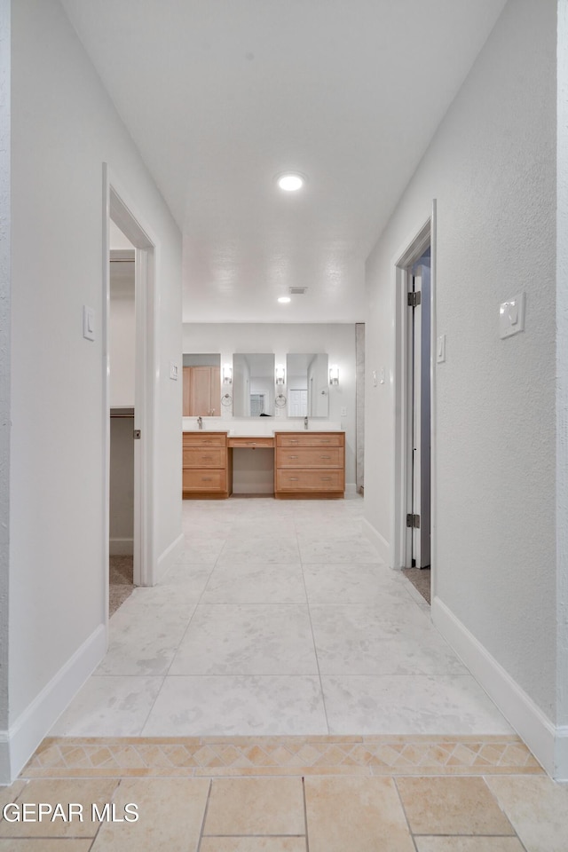 corridor featuring light tile patterned floors