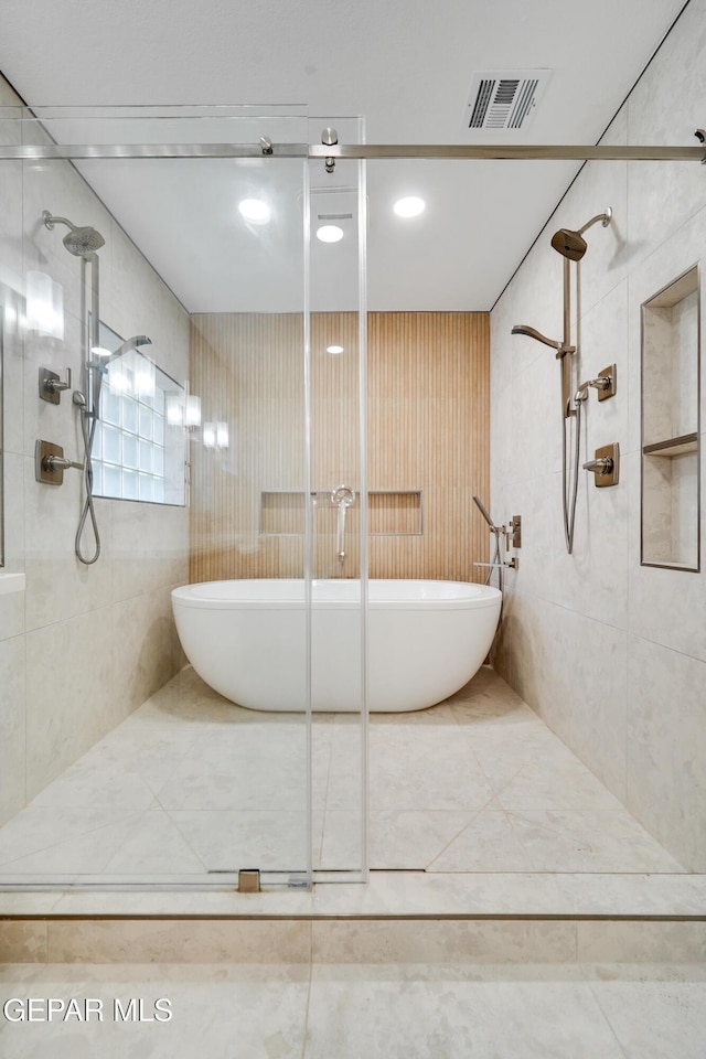 bathroom featuring shower with separate bathtub