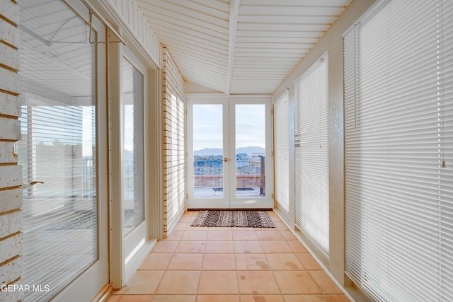 unfurnished sunroom with a mountain view and french doors