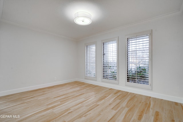 spare room with light hardwood / wood-style flooring and ornamental molding