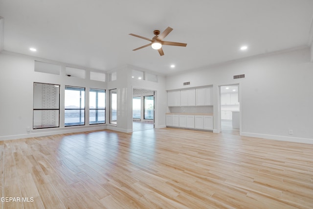 unfurnished living room featuring light hardwood / wood-style flooring and ceiling fan