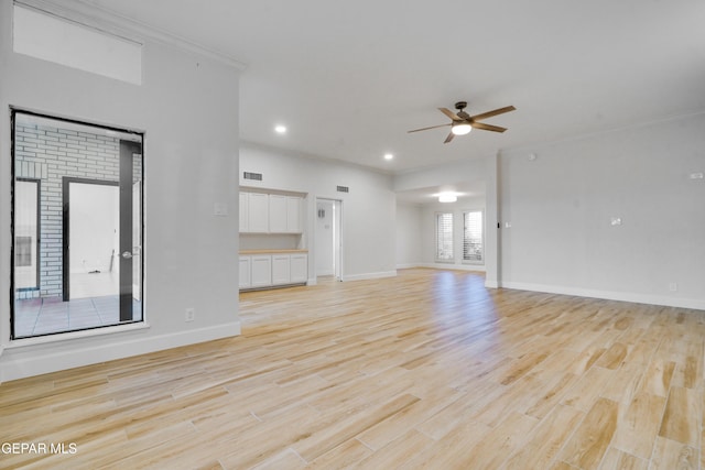 unfurnished living room with light hardwood / wood-style flooring, ceiling fan, and crown molding