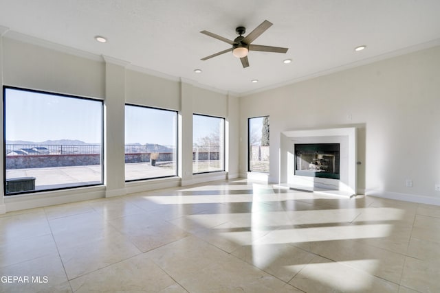 unfurnished living room with ceiling fan, crown molding, light tile patterned floors, and a healthy amount of sunlight