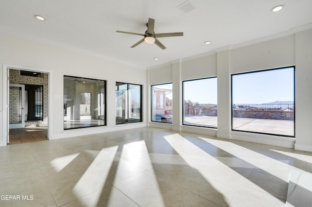 empty room featuring ceiling fan and ornamental molding