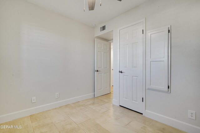 unfurnished bedroom featuring ceiling fan and light tile patterned floors