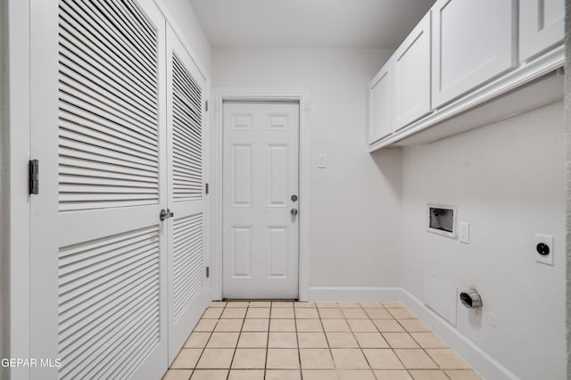 clothes washing area with cabinets, light tile patterned floors, hookup for an electric dryer, and washer hookup