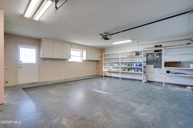 garage featuring electric panel and a garage door opener