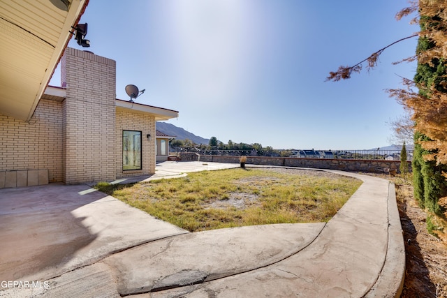 view of yard with a mountain view and a patio area