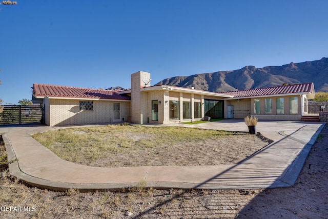 back of property with a mountain view