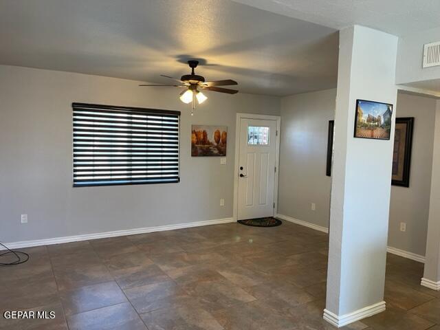 foyer entrance with ceiling fan