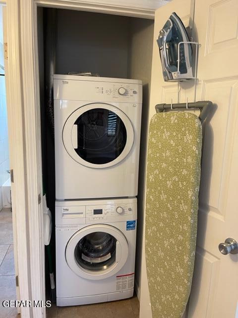 washroom featuring stacked washing maching and dryer