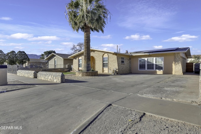 ranch-style home with solar panels